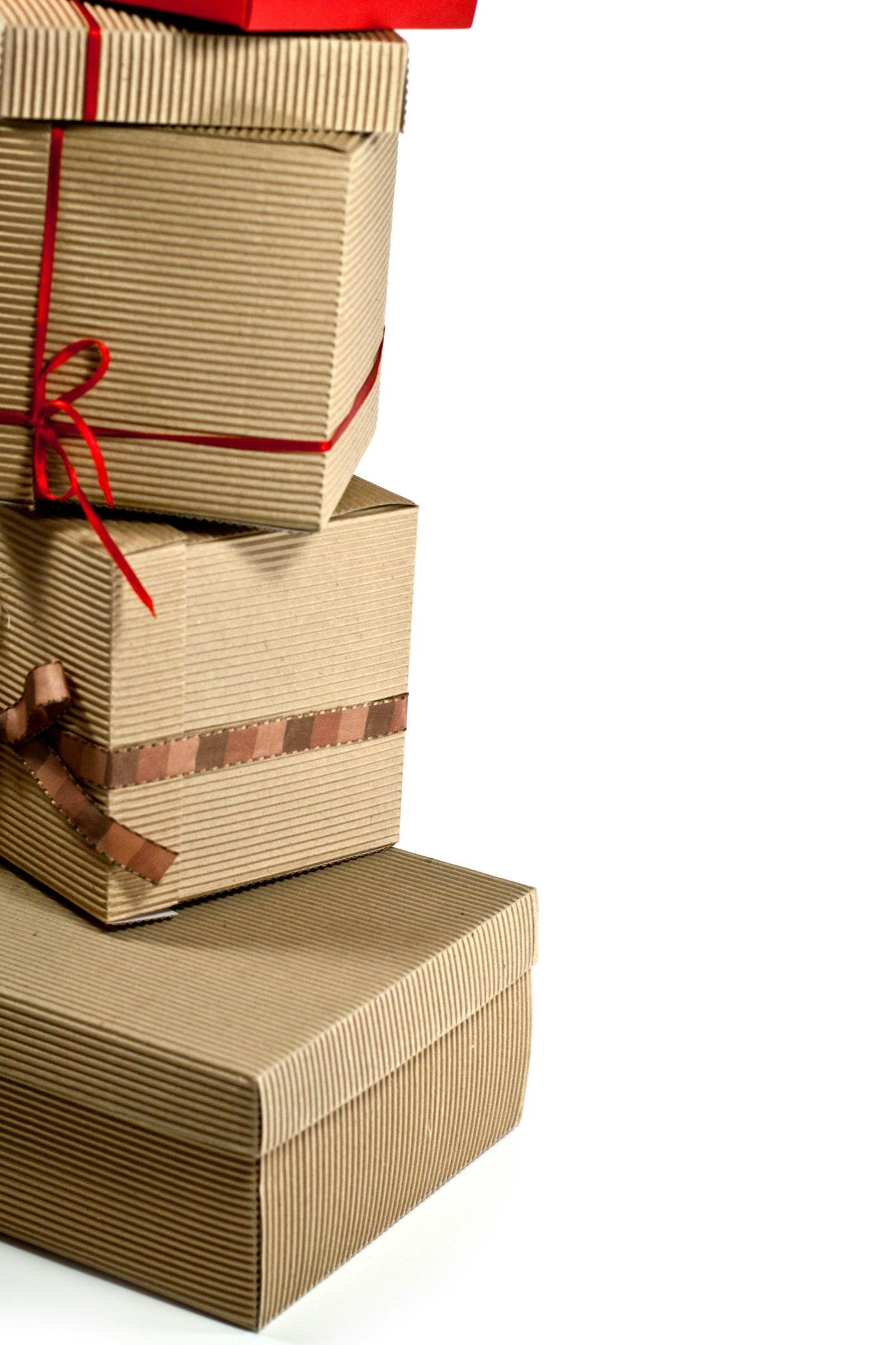 Three parcels wrapped in kraft paper and tied with red twine